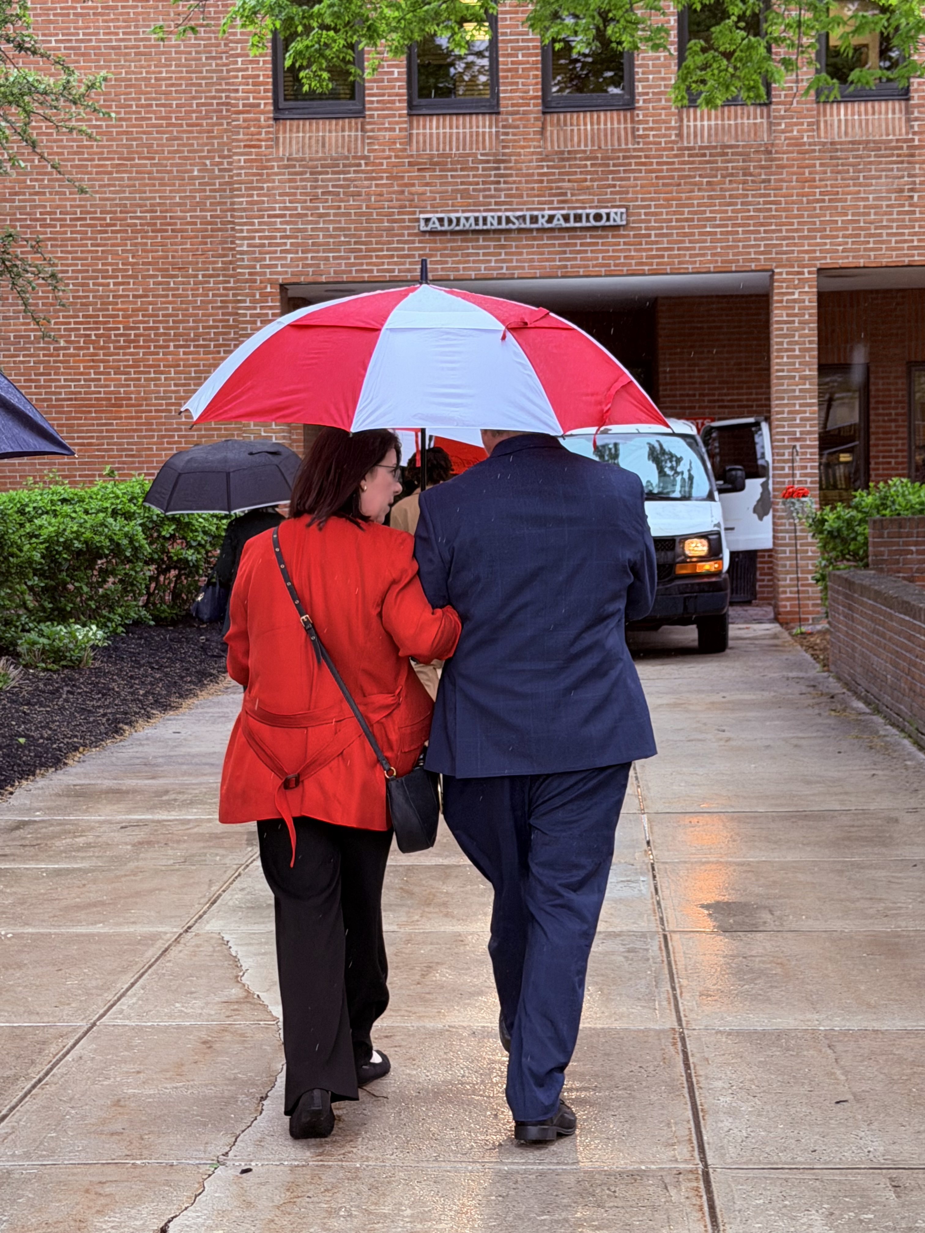 President Shadow and Jennifer walk back to his office in the rain